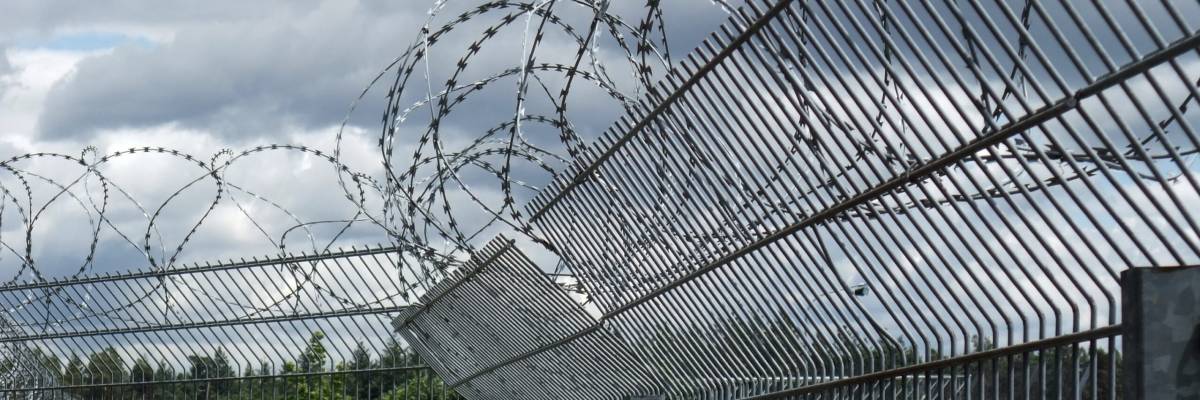 detail of a safety fence near a racetrack in Southern Germany named "Hockenheimring" in dramatic clouded ambiance